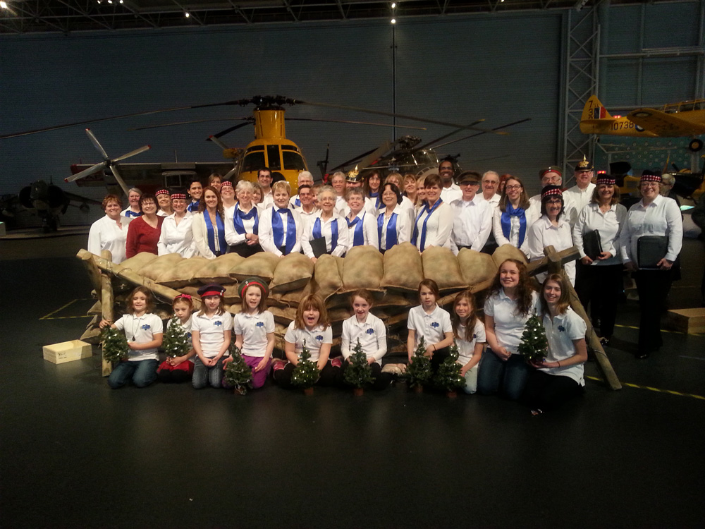 Members of the JJs and GJS who participated in the December 2014 recreation of the 100th annivesary of the Christmas truce. At the Canadian Aviation and Space Museum, Ottawa, ON both sides were represented (we were the German troops) singing Christmas carols first across no man’s land then together in no man’s land. Choirs representing both sides are shown here
